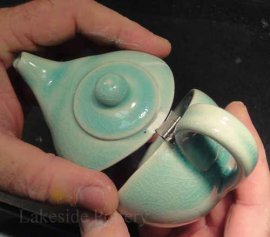 miniature hinged teapot used as a ring bearer